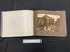 Inside layout shows brown card pages, right side contains a sepia toned 6x8 photograph, left side show a protective paper sheet with a paragraph of text in brown print outlined with a single line border.
