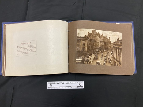 Inside layout shows brown card pages, right side contains a sepia toned 6x8 photograph, left side show a protective paper sheet with a paragraph of text in brown print outlined with a single line border.