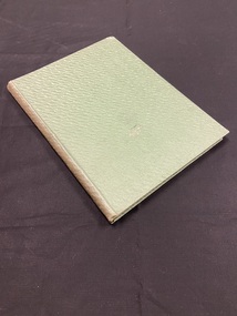 Faded green hardback book with no markings on the spine or cover.