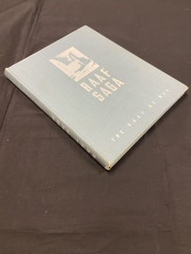 Cloth bound hardback book with faded blue cover. Title printed in white print on cover and spine. Image of the outline of a plane propeller in the top centre of cover.