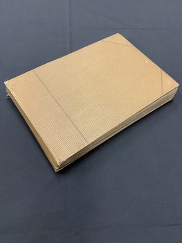 Brown hardback album with a thin dark line running vertically down the front cover an inch in from the spine and a diagonal line across the two corners of the cover on the right side.