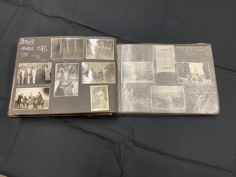 The inside pages are black card separated by protective translucent pages.  This layout shows 7 photos on the left with handwritten annotations and 4 photos on the right with annotations beneath the translucent paper.