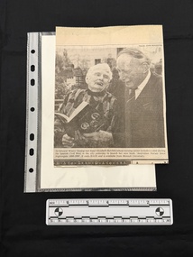 A newspaper clipping consisting of a black and white photograph of Sir Edward 'Weary' Dunlop and Sister Elizabeth Burchill.  