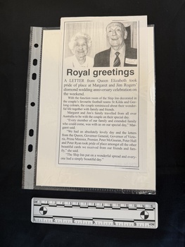 A photocopy of a newspaper article consisting of a photograph of an elderly man and woman, with one column of text beneath.  
