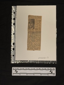 Newspaper clipping with one column of text and a small black and white photograph of a woman wearing a hat.