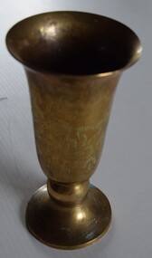 Brass, conical shaped vase with etched decoration around base and sides.