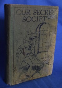 Children's adventure story, Our Secret Society, with cloth bound hard cover with drawing of a boy with a dog, next to a window. Book presented as am Attendance Prize to William Fry at Garibaldi School, 1931.