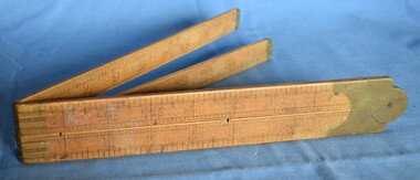 Folding 36-inch wooden ruler with brass hinges.
