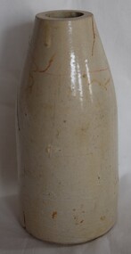 Pale  coloured, bottle shaped ceramic jar with no stopper. Has a partial but illegible maker's mark.