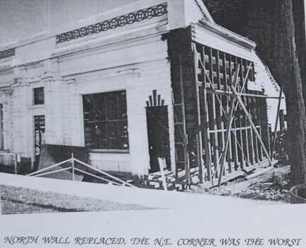 Image showing sections of cladding and weatherboards on the north wall and corner of the facade removed for replacement or repair. 1980s.