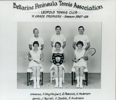 Group of tennis players, some holding racquets