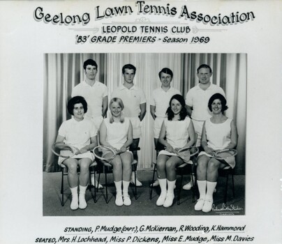 Group of tennis players, some holding racquets