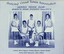 Group of tennis players holding racquets.