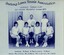 Group of tennis players holding racquets.
