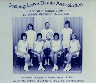 Group of tennis players holding racquets.