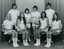 Group of tennis players holding racquets.