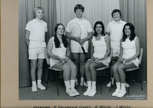 Group of tennis players holding racquets.