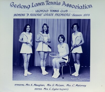 Group of tennis players holding racquets