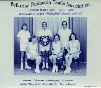 Winning divisional tennis team with trophy