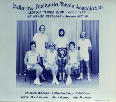 Winning divisional tennis team with trophy