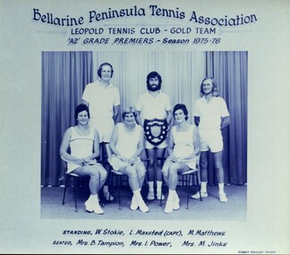 Winning divisional tennis team with trophy
