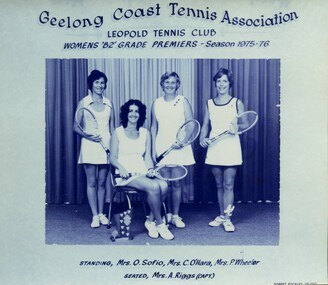 Winning divisional tennis team with racquets and trophy