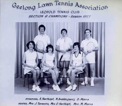 Winning divisional team with tennis racquets