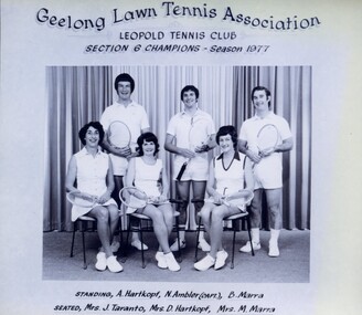 Winning divisional team with tennis racquets