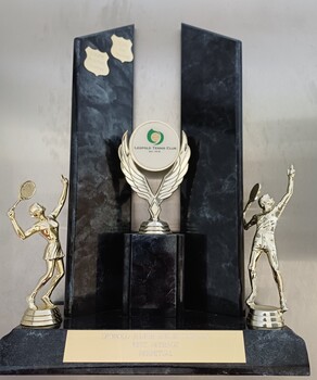 Plastic and wooden trophy with male and female tennis players