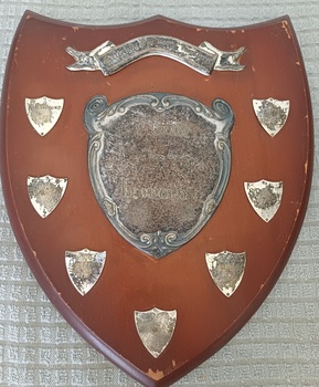 Wooden shield with inscribed silver plates