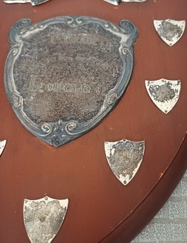 Wooden shield with inscribed silver plates
