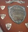 Wooden shield with inscribed silver plates