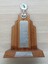Wooden trophy with golden disc at top and crossed tennis racquets below