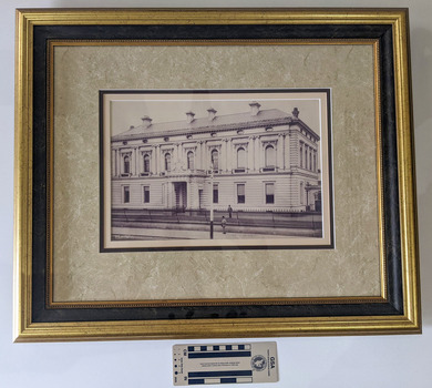 Black and White photograph of a grand two story Victorian Era building. 