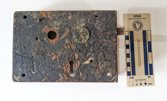 Corroded door lock mechanism with a key hole. Some oxidation has occurred. 