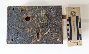 Corroded door lock mechanism with a key hole. Some oxidation has occurred. 