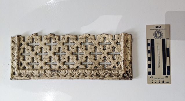 A section of a ventilation grate with a cross-hatch pattern painted cream.