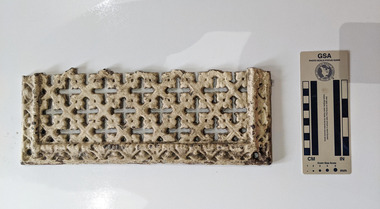 A section of a ventilation grate with a cross-hatch pattern painted cream.