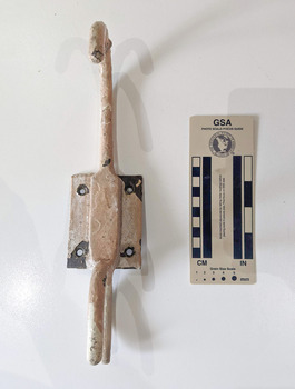 Iron hook with a wall plate painted cream.