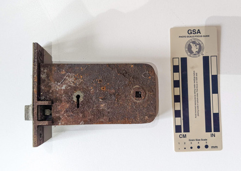 Rusted door lock with key hole in the bottom left corner. 