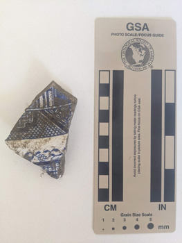 Ceramic shard with white glaze and blue decorative pattern