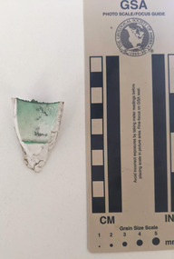 Ceramic shard with white and green glazed finish 