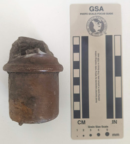 Cylinder shaped piece of brown ceramic