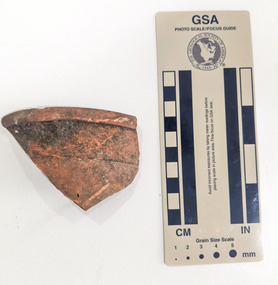 Ceramic shard with orange finish 