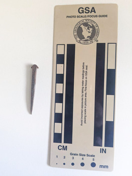 Medium sized corroded nail with a square head