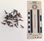 Collection of corroded tacks with a circular head.