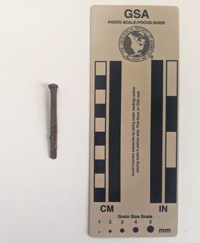 Corroded nail with a rose head with a star.