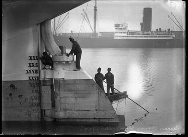 Photograph, Lascars cleaning ship's rudder