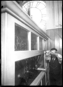 Photograph, Bull, Hugh Jones, 1897-1993, Winding Melbourne Town Hall clock by hand for the last time