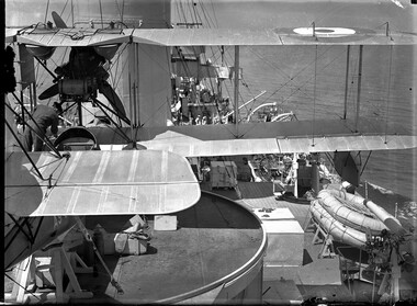 Photograph, Bull, Hugh Jones, 1897-1993, Australian Navy Supermarine Seagull III bi-plane on a ship with mechanic (right side)